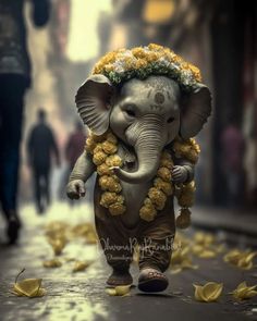 an elephant with flowers on its head walking down the street