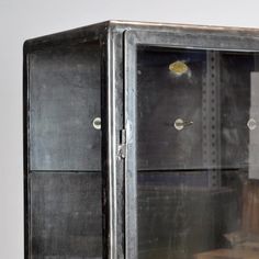 an old metal cabinet with glass doors