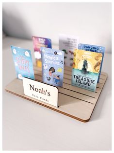 there are many books on the wooden shelf with name tags in front of them and one is for noah's