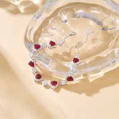 Love happens unexpectedly, can you hear your heart pounding? The heart symbolizes eternal love. Many people believe that multiple intertwined hearts, like joined circles, represent never-ending love. Designed for those born in July, our Eternity Heart Tennis Bracelet adds a personal touch to our bestselling pink Ms. Charming Bracelet. Birthstone - Jul - Ruby Heart symbol has its universal meaning of love, that is why heart inspired jewelry designs are so classy and popular. Love comes in so many Heart Tennis Bracelet, Ruby Chain, Charming Bracelet, Intertwined Hearts, Born In July, Silver Tennis Bracelet, Ruby Heart, Bow Women, Tennis Gifts