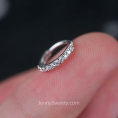 someone is holding their wedding band in their hand, with the ring on it's finger