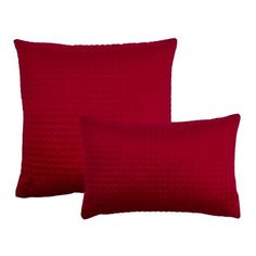 two red pillows sitting next to each other