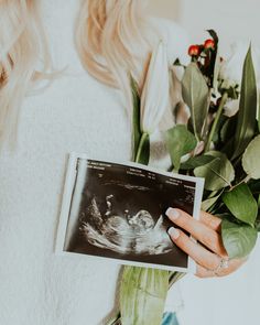 a woman holding a bouquet of flowers and an x - ray image in her hand