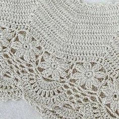 a crocheted shawl with flowers on it