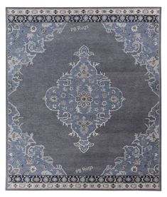 a blue rug with an ornate design on the front and back side, in various colors