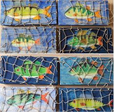 four tiles with fish painted on them