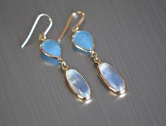 Lovely genuine sea blue aquamarine & blue moonstone is set in 14k gold. Lightweight and gorgeous, these are a great gift for anyone on your list. Perfect for everyday wear or for those who like to make a dainty minimalist statement. Size : 40x8mm Metal : 14kt Gold Gemstones : Aquamarine, Moonstone More about Aquamarine ... The serenely colored aquamarine invokes the tranquility of its namesake, the sea. In fact, the name aquamarine is derived from the Latin word aqua, meaning water, and mari Blue Gemstone Earrings, Latin Word, Minimalist Studs, Gift Girlfriend, Earring Gift, Aquamarine Jewelry, Blue Moonstone, Moonstone Earrings, June Birthstone