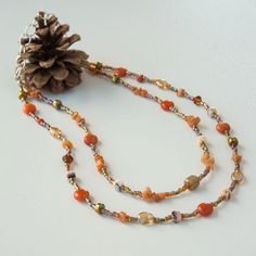 Autumn is just around the corner! This double-strand beaded necklace is made of red agate stones, aventurine chips, Czech glass, crystal, glass seed beads and silver-tone accent beads. It is finished with silver-tone stainless steel chain. Orange Double Strand Beaded Necklace As Gift, Handmade Orange Double Strand Necklace, Orange Multi-strand Polished Beaded Necklaces, Orange Multi-strand Beaded Necklace With Polished Beads, Orange Double Strand Beaded Necklace For Gift, Orange Multi-strand Polished Beaded Necklace, Brown Czech Glass Beaded Necklaces With Gemstone Beads, Brown Czech Glass Gemstone Beaded Necklaces, Brown Czech Glass Beaded Necklace With Gemstone Beads