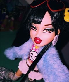 a close up of a doll wearing sunglasses