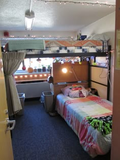 a bunk bed in a small room with lights on the ceiling and curtains hanging over it