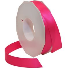 a roll of pink satin ribbon on a white background