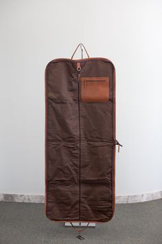 Experience luxurious travel with the Hair on Hide Gloria Garment Bag. Designed for weekend getaways by road or air, this essential bag flawlessly holds 6-12 articles of clothing depending on thickness. Crafted with beautiful hair on hide and leather, it boasts a 2-way full-zip closure for securing your outfits. Convenient features include an inside zipper pocket, outside zipper pocket, luggage tag ring, and hanging o-ring. The durable canvas interior, trimmed in leather, ensures reliable protect Luxury Brown Weekender Bag With Zipper Closure, Brown Leather Trim Travel Bag For Business Trips, Elegant Brown Travel Bag With Zipper Closure, Luxury Weekender Bag With Leather Backing For Trips, Elegant Brown Travel Bag For Weekend Trips, Elegant Brown Travel Bag For Trips, Luxury Weekender Bag For Trip, Brown Luxury Travel Bag, Luxury Brown Luggage With Dust Bag Included