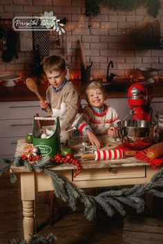 two young boys are making christmas cookies together in the kitchen with red mixers and other holiday decorations