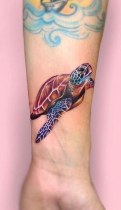 a small turtle tattoo on the wrist