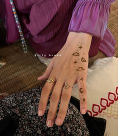 a woman's hand with tattoos on it