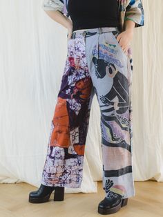 Step into the world of sustainable fashion with our Sugar Cream upcycled trousers. Crafted from unique tribal wax print in bold, vibrant colors, these wide leg trousers are an exquisite addition to your wardrobe. The elasticated waist with belt loops and button, along with front pockets, offer both comfort and style. Embrace ethical fashion with these immaculate, special trousers. Care: Cool machine wash. Dry at a lower heat and press with a medium iron.  Condition: Please note due to this piece Multicolor Wide Leg Bottoms With Abstract Print, Multicolor Abstract Print Wide Leg Bottoms, Multicolor Bold Print Wide Leg Pants, Multicolor Wide-leg Pants With Bold Print, Multicolor Relaxed Fit Wide Leg Pants, Upcycled Trousers, 12 December, Artisan Gift, Wax Print