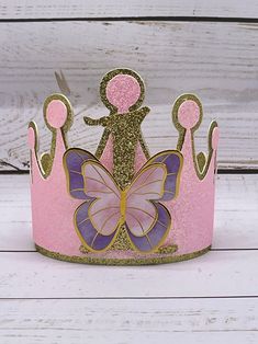 + gold + pink sparkle tiara adorned with a sparkle gold 1 + pastel purple + pink butterflies   packaged inside a coordinating gift box Whimsical Gold Crown For Party, Whimsical Tall Crown As Gift, Whimsical Pink Crown For Birthday, Pink Pinched Crown For Party, Gold Tall Crown As Gift, Gold Birthday Crown With Tall Shape, Gold Tall Crown For Birthday, Princess Crown Party Supplies For Birthday, Pink Princess Crown For Party