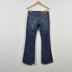 "Condition: Good! Some light wear. Brand: Von Dutch Color: dark wash (color is most accurate in flat lay images) Tag Size: 28 (please view measurements for accurate sizing) Low rise so these would fit best on a 25/26 in my opinion.  MEASUREMENTS: Waist (doubled): 30\" Hips (doubled): 36\" Rise: 7.75\" Thigh Width (doubled): 19\" Inseam: 29.5\" Ankle (doubled): 18\" BEFORE PURCHASING PLEASE MAKE SURE TO MEASURE YOURSELF!  All pants are normally a little darker than the image because of the camera Y2k Style Dark Wash Cotton Flare Jeans, Von Dutch 2000s, 2000s Low Rise, Slim Hips, Vintage Denim Jeans, White Patches, Von Dutch, Arizona Jeans, Womens Jeans