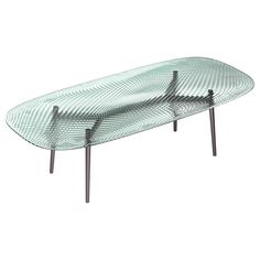 a glass table with two metal legs and a wavy design on the top, against a white background