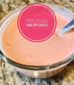 a pink sauce in a glass bowl with a spoon