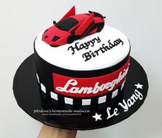 a birthday cake with a red car on top