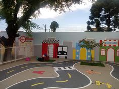 a child's play area with painted walls and street markings on the pavement,