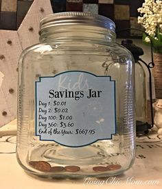 a glass jar filled with coins sitting on top of a table