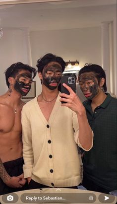 three men with facial masks on taking a selfie