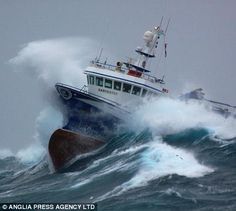 a boat is in the middle of a large wave