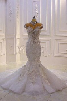 a white wedding dress on display in a room