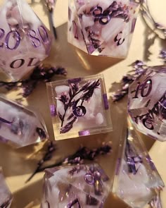 several clear dices with purple flowers on them