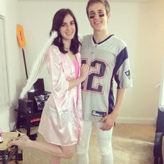 a man and woman are dressed up in football uniforms, posing for the camera with their arms around each other