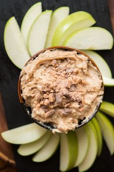 an apple and peanut butter spread on top of some sliced up apples in a bowl