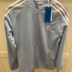 Baby Blue Adidas Track Jacket Size Xl, New With Tags, Never Worn Blue Sporty Outerwear With Ribbed Cuffs, Sporty Blue Outerwear With Ribbed Cuffs, Casual Blue Adidas Outerwear, Blue Track Jacket For Spring Streetwear, Blue Track Jacket With Ribbed Cuffs For Winter, Blue Track Jacket With Ribbed Cuffs For Fall, Blue Winter Track Jacket With Ribbed Cuffs, Casual Blue Track Jacket For Winter, Winter Blue Track Jacket With Ribbed Cuffs