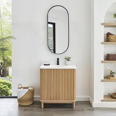 a bathroom with a sink, mirror and shelving unit in the corner next to it