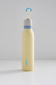 a yellow and blue water bottle sitting on top of a white table