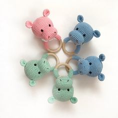 four crocheted toy animals sitting on top of each other in the shape of rings