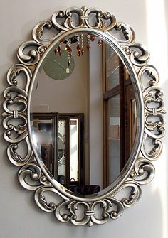 a round mirror hanging on the wall