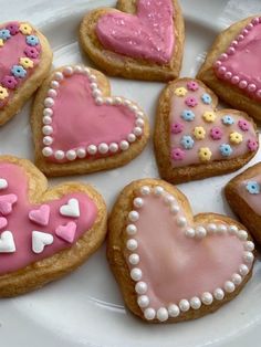 some heart shaped cookies are on a plate