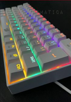 a close up of a computer keyboard with multicolored keys and lights on it