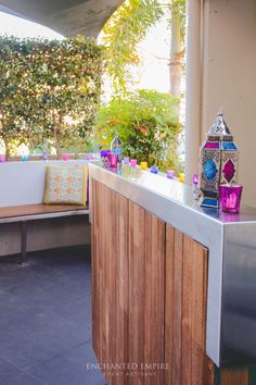 an outdoor kitchen with wooden counter tops and tiled flooring