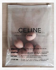 some eggs are in a plastic bag on a wooden table with the words celine written above them