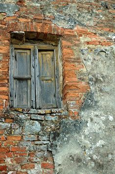 an old brick building with a wooden window