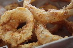 fried onion rings sitting in a container