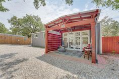 an outdoor patio area with a red and white awning