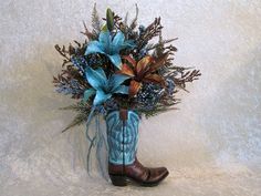 a cowboy boot with flowers in it on a white wallpapered background for display