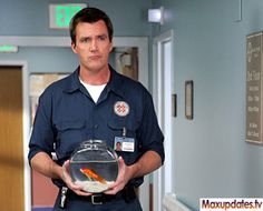 a man in uniform holding a fish bowl