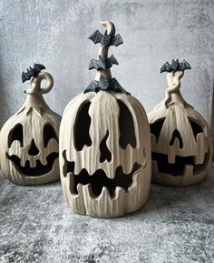 three carved pumpkins sitting on top of a table