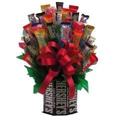 a bouquet of candy and candies in a box with a bow on the top