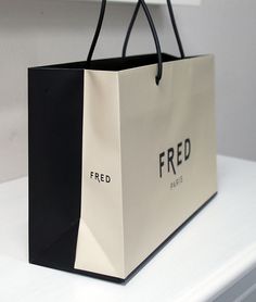 a black and white shopping bag sitting on top of a counter